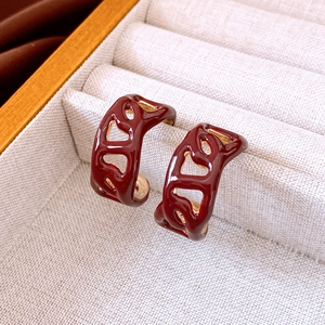 Macro shot of deep red enamel irregular earrings with 18K gold plated metal interior
