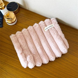 Close-up of pink plush cosmetic bag with ribbed texture and A GOGO ORIGINAL fabric label