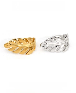 Detail of PVD plated stainless steel rings in gold and silver leaf shape design