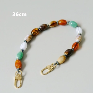 Detail of 36cm colorful oval resin bead chain with gold lobster clasps and glossy finish