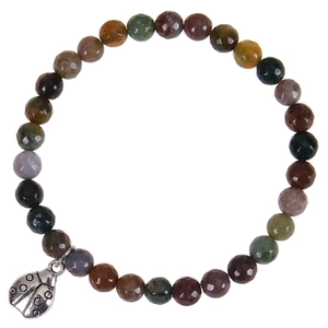 Detailed macro view of faceted gemstone beads and a silver ladybug charm on a stretch bracelet