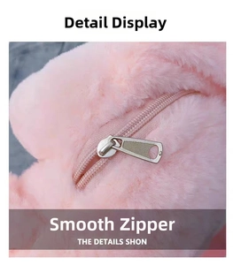 Detail view of smooth metal zipper and soft pink plush texture on the toy backpack