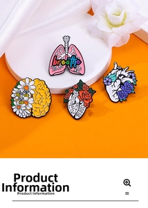 Macro view of anatomical heart and lung enamel pins with floral details on white fabric