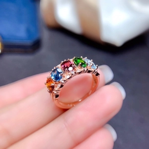 Rose gold multi-gemstone ring with five oval colorful crystals in an open band setting