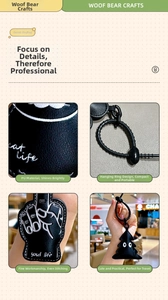 Detail of black leather cat-themed bag charm with neat stitching and sturdy strap ring