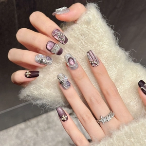 Handmade press-on nails with purple cat-eye base and glitter cross charms for a luxury look