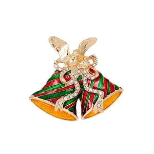 Close-up of Christmas bell brooch with red and green enamel and white rhinestones