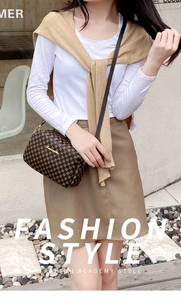 Detail of dark brown geometric pattern crossbody bag with golden chain and hardware