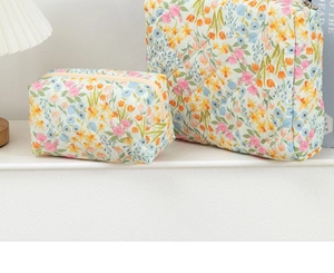 Detailed view of quilted cotton floral cosmetic bags in large and small two-piece set