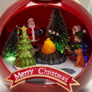 Illuminated Christmas snow globe music box with festive miniatures and LED light