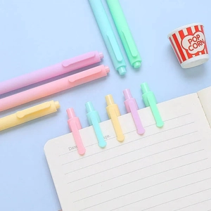 Pastel macaron retractable gel pens set with popcorn accessory on a blue background