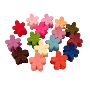 Matte mini flower hair clips in various macaron colors on white background