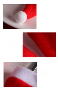 Detail of red Christmas hat showing white pom-pom, felt texture and neat stitching