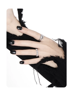 Detail of S925 sterling silver feather texture ring and diamond band on model's hand