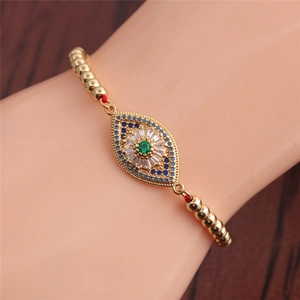 Adjustable golden evil eye bracelet featuring green zircon and blue beaded accents