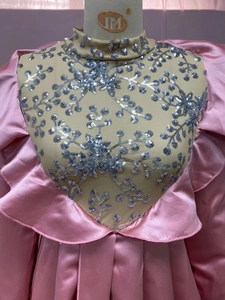 Detailed close-up of pink satin evening dress with sequined floral embroidery on mesh