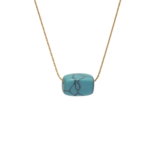 Gold-plated stainless steel necklace with rectangular blue turquoise pendant on white background