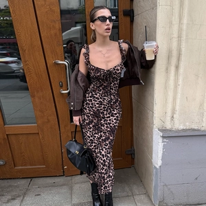 Slim fit leopard print cami maxi dress styled with a brown jacket in a street shot