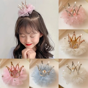 Detail view of various colorful crown hairpins featuring lace, pearls and crystals