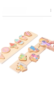 Detail of wooden puzzles with food and vehicle themes for toddler early learning