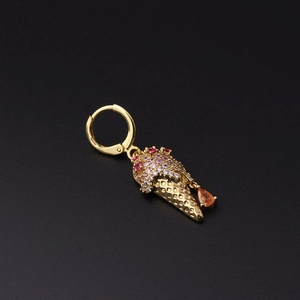 Detail of gold ice cream huggie earring with white and red zircon micro-pave