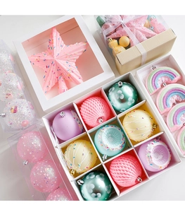 Close-up of pink glittered Christmas tree topper star and colorful macaron ornament set