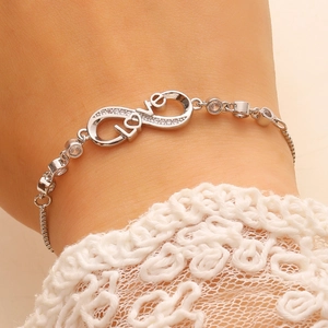 Detail of adjustable silver infinity love bracelet with zircon stones and sliding clasp