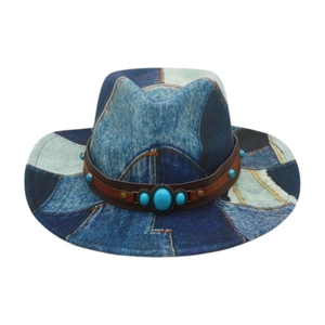 Detail of western fedora hat with blue patchwork print and leather band with turquoise studs