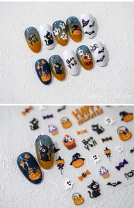 Macro detail of 3D embossed Halloween nail stickers with cute black cat and pumpkin designs