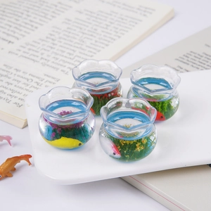 Set of four miniature fish tanks with colorful koi and aquatic plants for micro landscapes