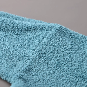 Macro detail of the soft high-density teal microfiber fabric and knit texture