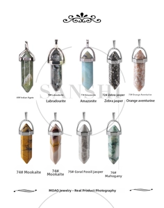 Macro shot of various hexagonal crystal quartz point pendants in diverse natural stones