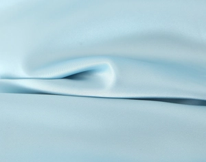 Detailed view of the light blue satin fabric showing silky texture and elegant drape