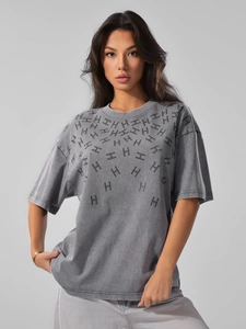 Close-up of vintage washed grey cotton t-shirt featuring radial H letter print detail