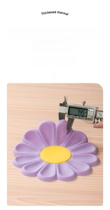 Detail showing caliper measurement of 7.45mm thickness for daisy silicone heat resistant mat