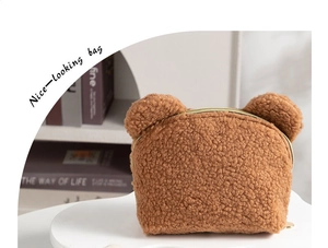 Close-up of brown teddy fleece makeup bag with cute bear ears and gold zipper closure