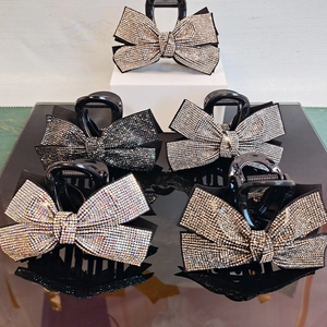 Five elegant bow hair claws with sparkling rhinestones in silver and black tones