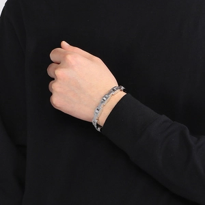 Macro detail of men's silver stainless steel watch-link bracelet with high polish finish