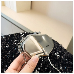 Macro shot of mirror-polished silver mini metal bag with elegant bead chain detail