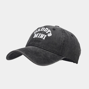 Detailed close-up of DADDY'S MINI embroidery on a distressed grey washed baseball cap
