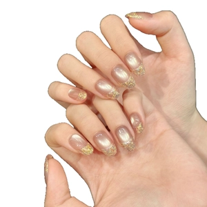 Champagne cat eye press-on nails with French golden glitter gradient on almond shape