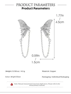 Detail view of silver butterfly ear cuff with sparkling diamonds and long chain drop