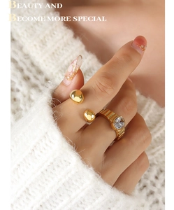 Detail of 18k gold-plated geometric rings with zircon inlay on a cozy knit background