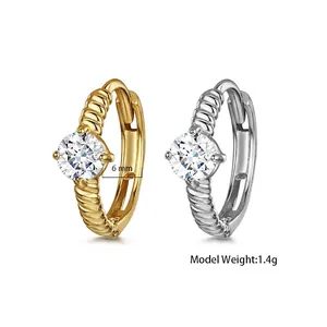 Detail of twisted rope earrings in gold and silver finish with 6mm cubic zirconia