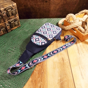 Detail of Aztec pattern crossbody bag with blue geometric print and vintage strap