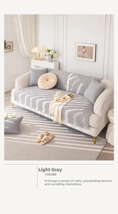 Close-up of quilted light gray sofa cover and cushion with diamond pattern embroidery