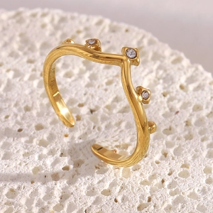 Detailed view of 18K gold plated wavy open ring with sparkling zircon stones