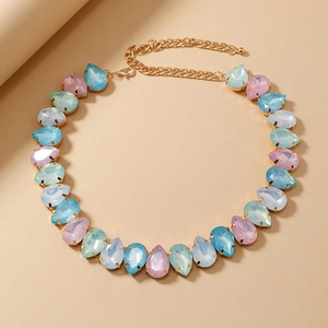 Detail of tear-drop pastel crystals necklace with gold-plated metal claw settings
