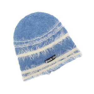 Detail of blue knit beanie featuring fuzzy white stripes and Blank vivi brand label
