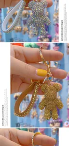 Detail of sparkling rhinestone bear keychain with crystal leather strap and metal clasp